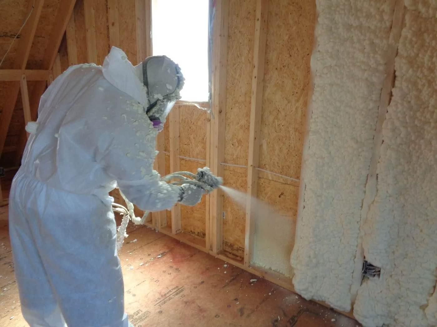 Volunteer FoamPros technician spraying foam insulation in the rafters of a Middle Tennessee home